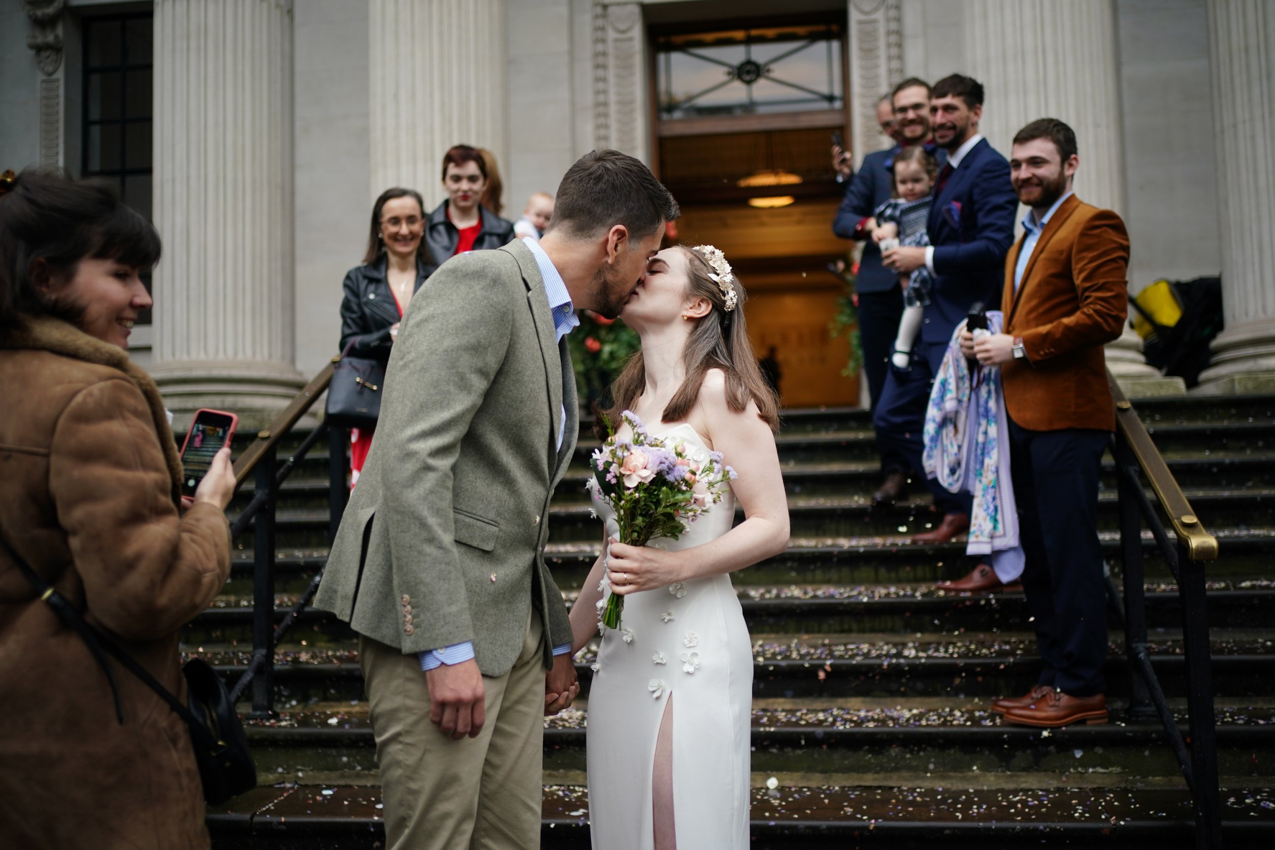 Newly married couple Christopher Hohls and Madeleine Crean, kiss on the steps of Old Marylebone Town Hall in London